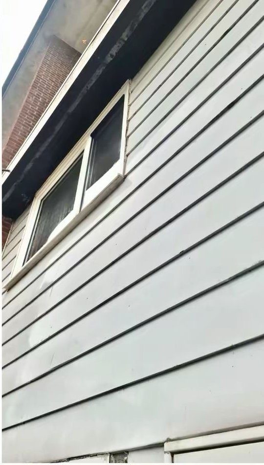 Same weatherboard after Eastrada softwash — algae lifted, surface restored
